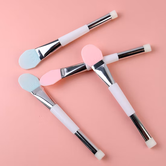 Applicateur de brosse de masque de boue de visage de silicone à double extrémité d'outil de beauté cosmétique pour l'hydratant de lotion de crème